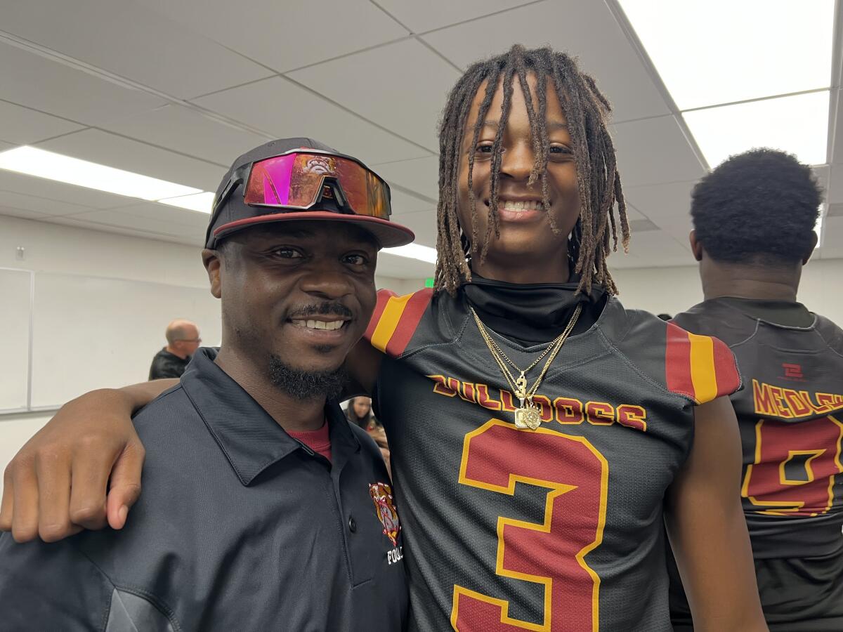 Highland coach Justin Wyatt with his quarterback o