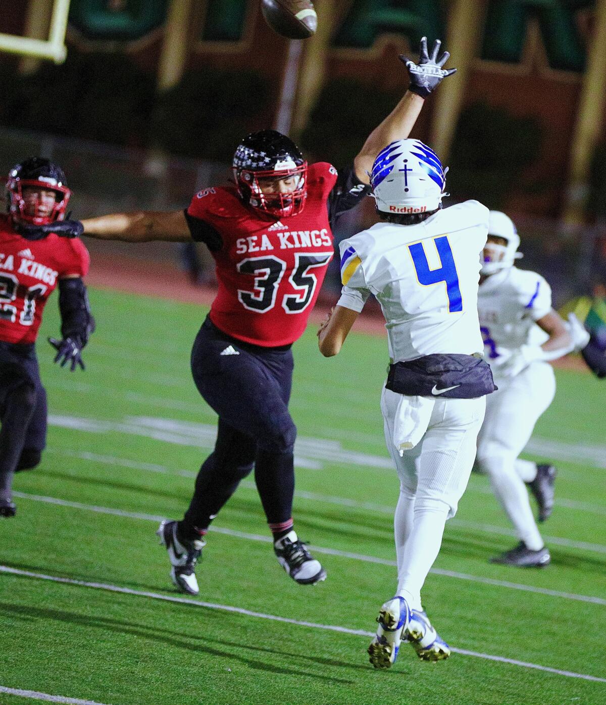 Junior defensive tackle Giuseppe Virzi of Palos Verdes pressures Bakersfield Christian quarterback Lincoln Adame.