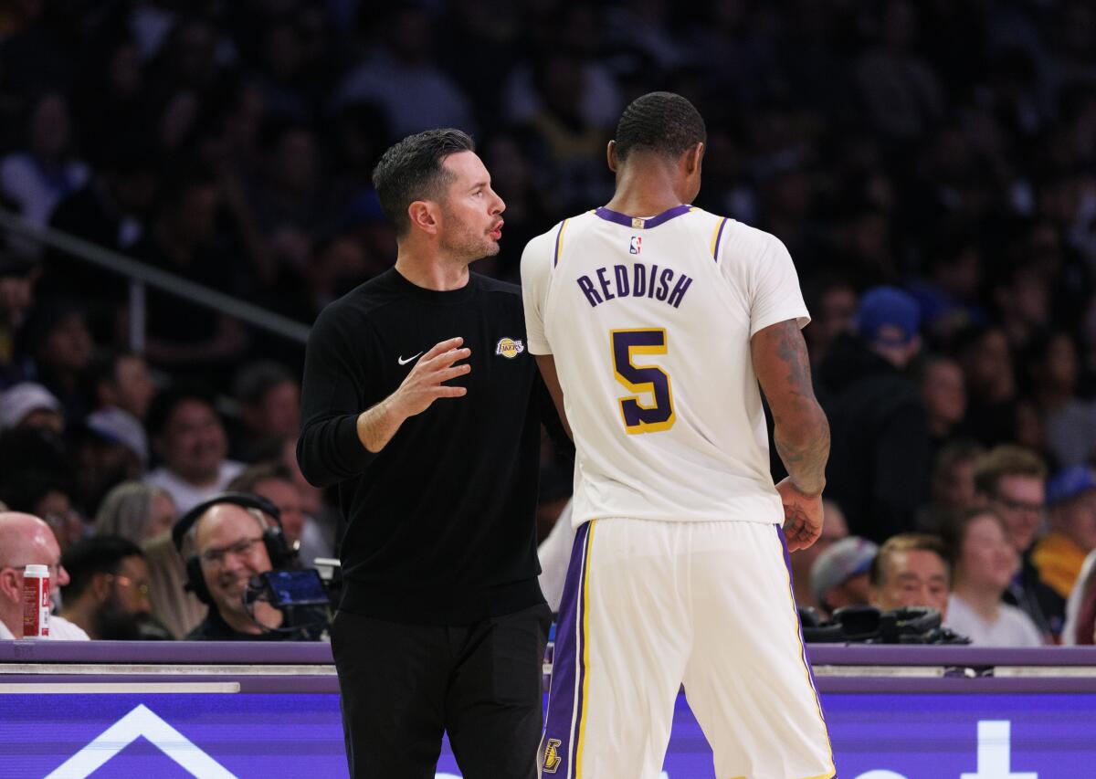 Lakers coach JJ Redick talks with forward Cam Reddish during the a game against the Trailblazers at Crypto.com Arena