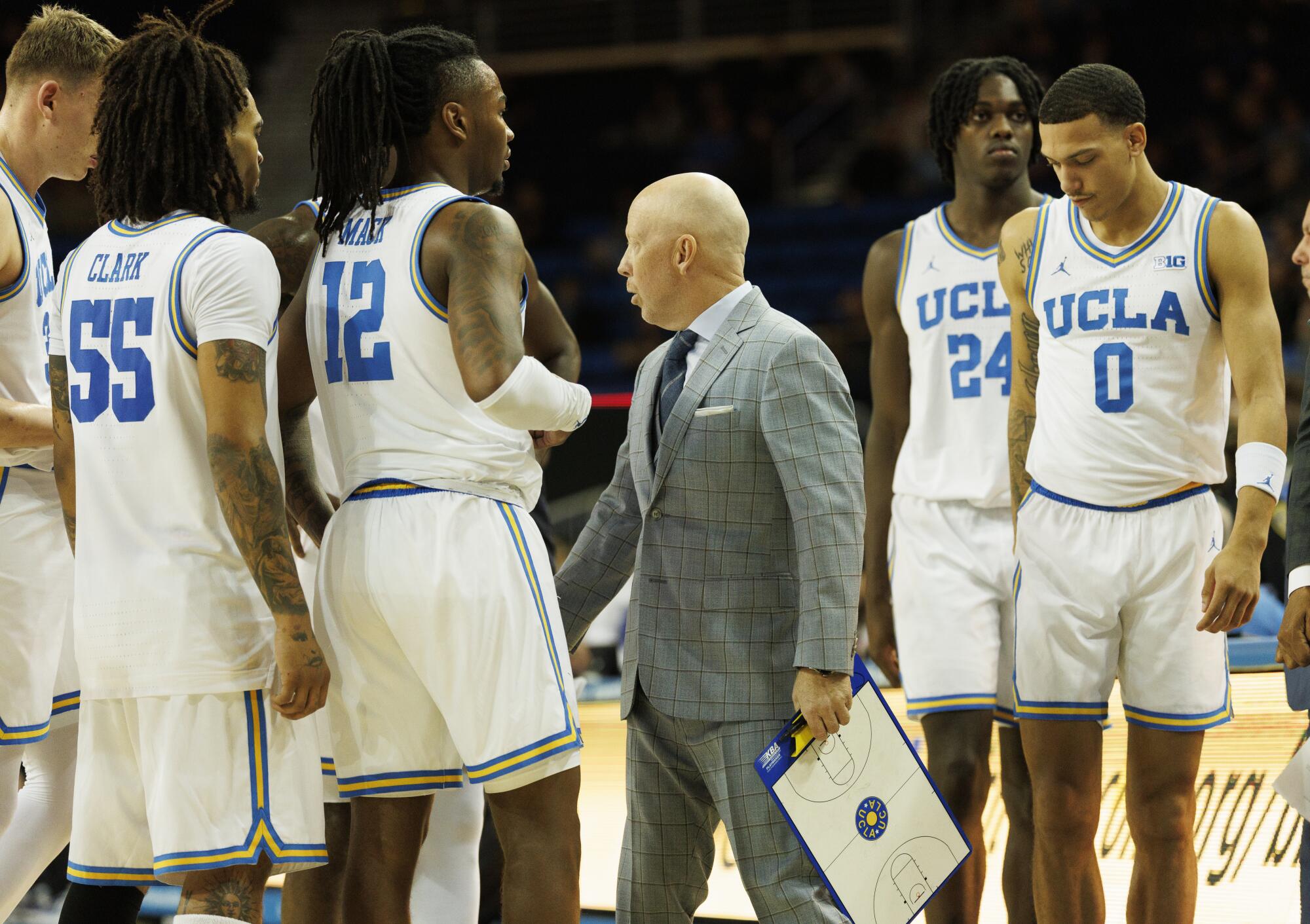 Mick Cronin speaks to his players during a win over Washington on Dec. 3.