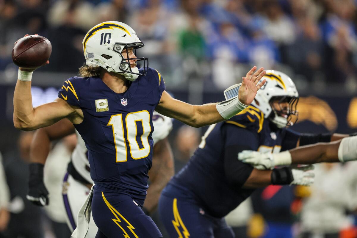 Chargers quarterback Justin Herbert (10) attempts a fourth-quarter pass against the Ravens.