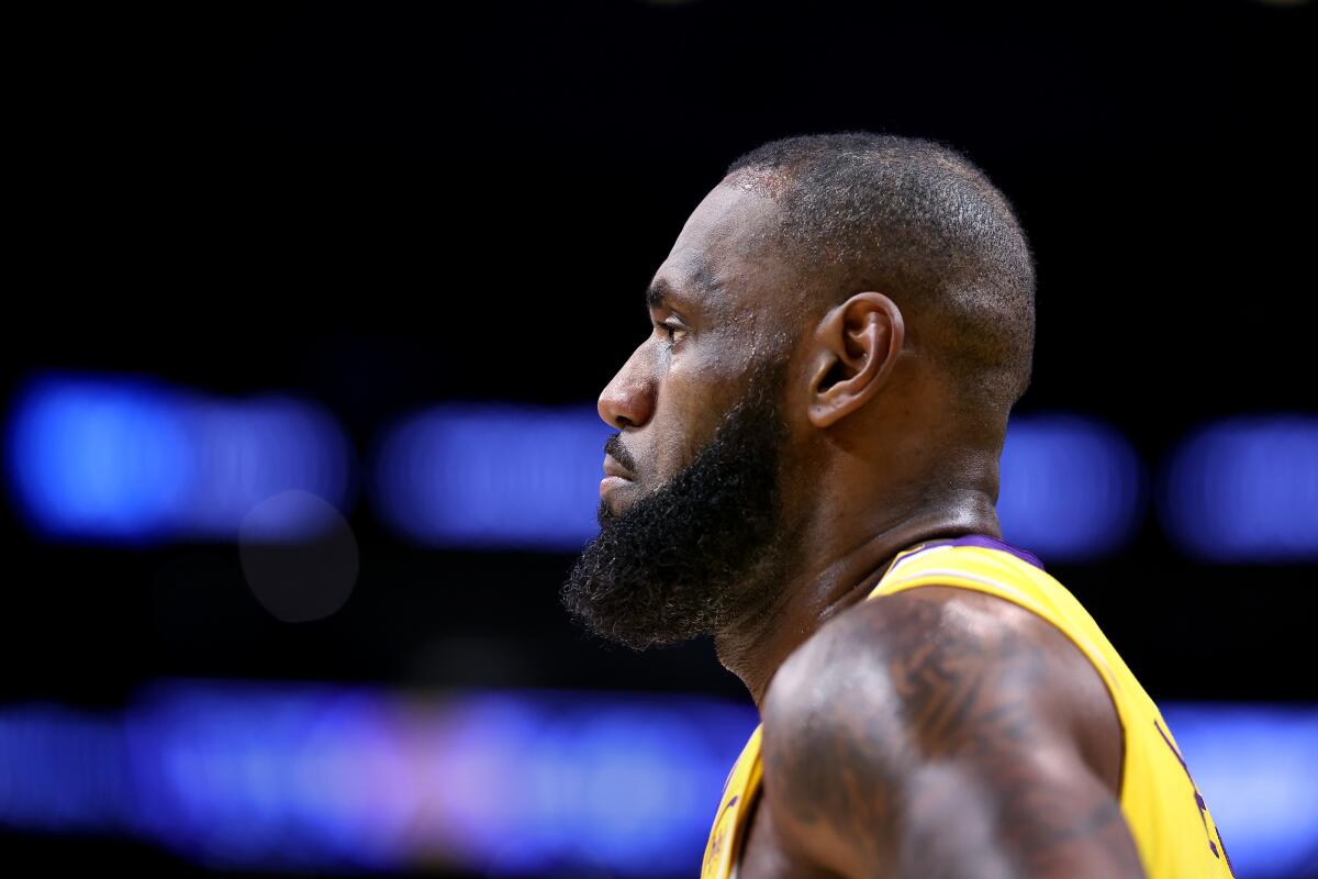 Lakers star LeBron James stands on the court before a game.