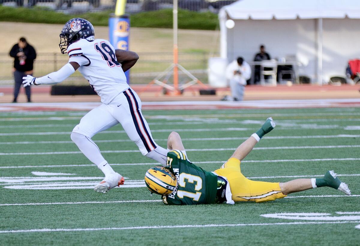 Edison defensive back Will Harrison trips up Fresno Central wide receiver Bayon Harris.