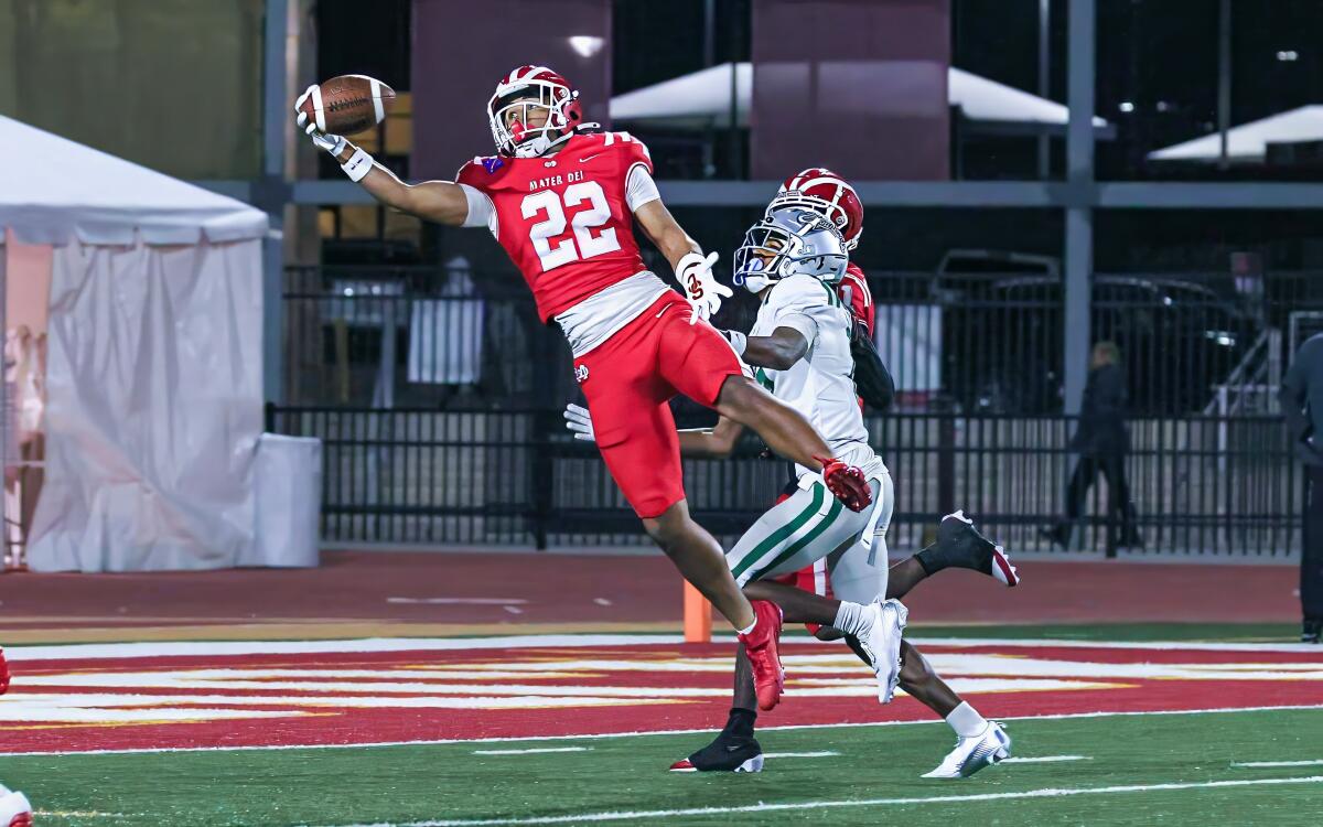 Mater Dei defensive back Ace Leutele makes a one-handed interception against De La Salle in the fourth quarter Saturday.