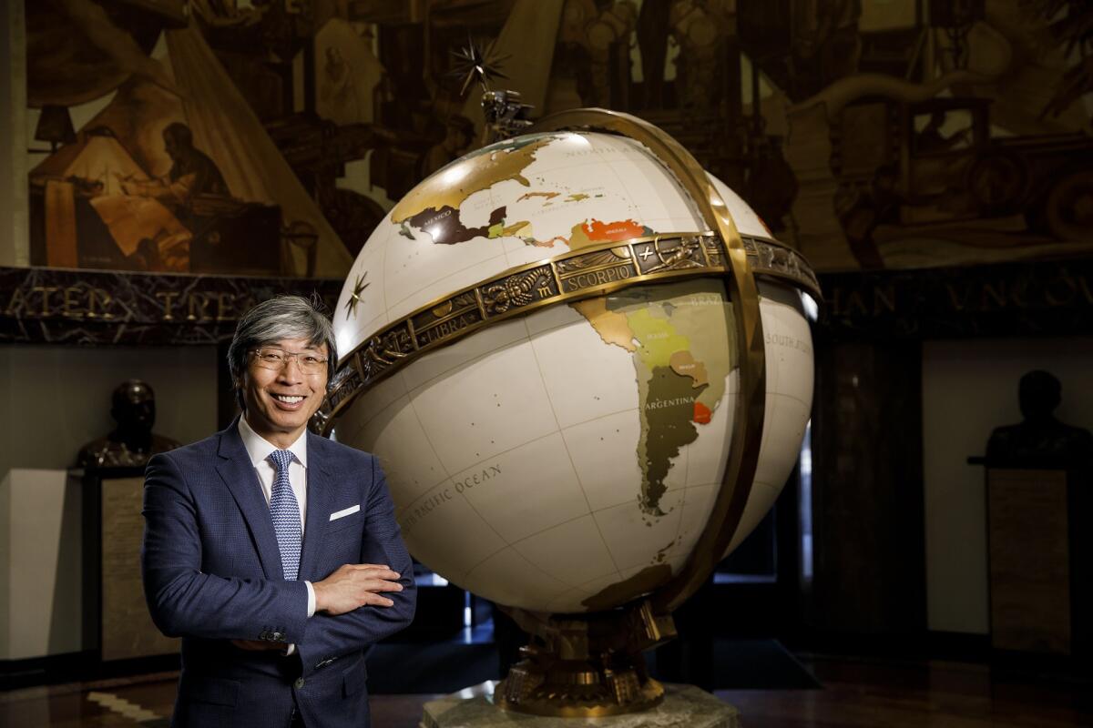 Patrick Soon-Shiong next to the globe in the old L.A. Times building