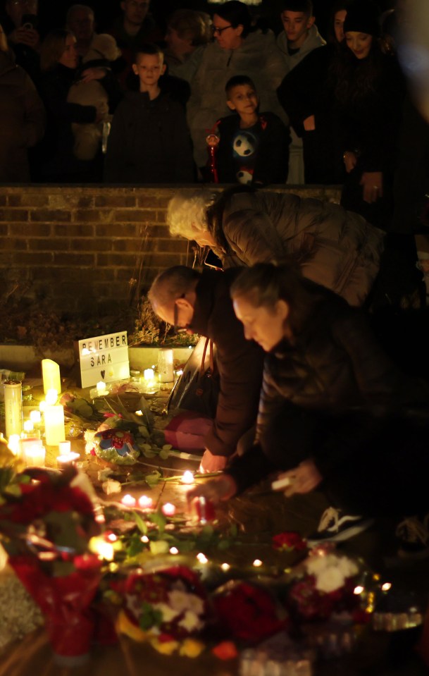 People gather and light candles in memory of tragic Sara, outside the house in Woking where she was brutally murdered