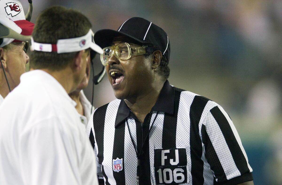 NFL field judge Al Jury explains a ruling to Kansas City Chiefs coaches.