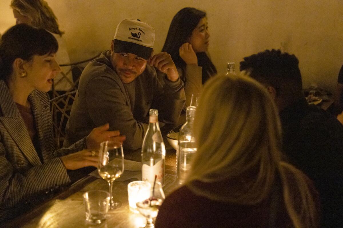 Strangers interact as they dine together at Bacari in Los Angeles on Wednesday, November 20, 2024. 