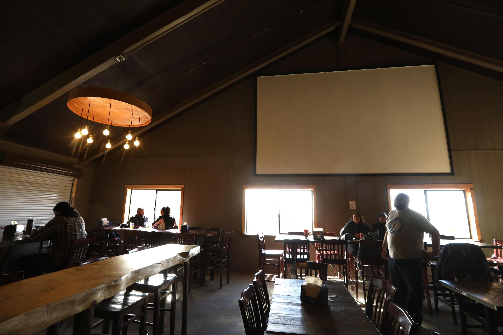 A handful of people seated at tables in a restaurant 