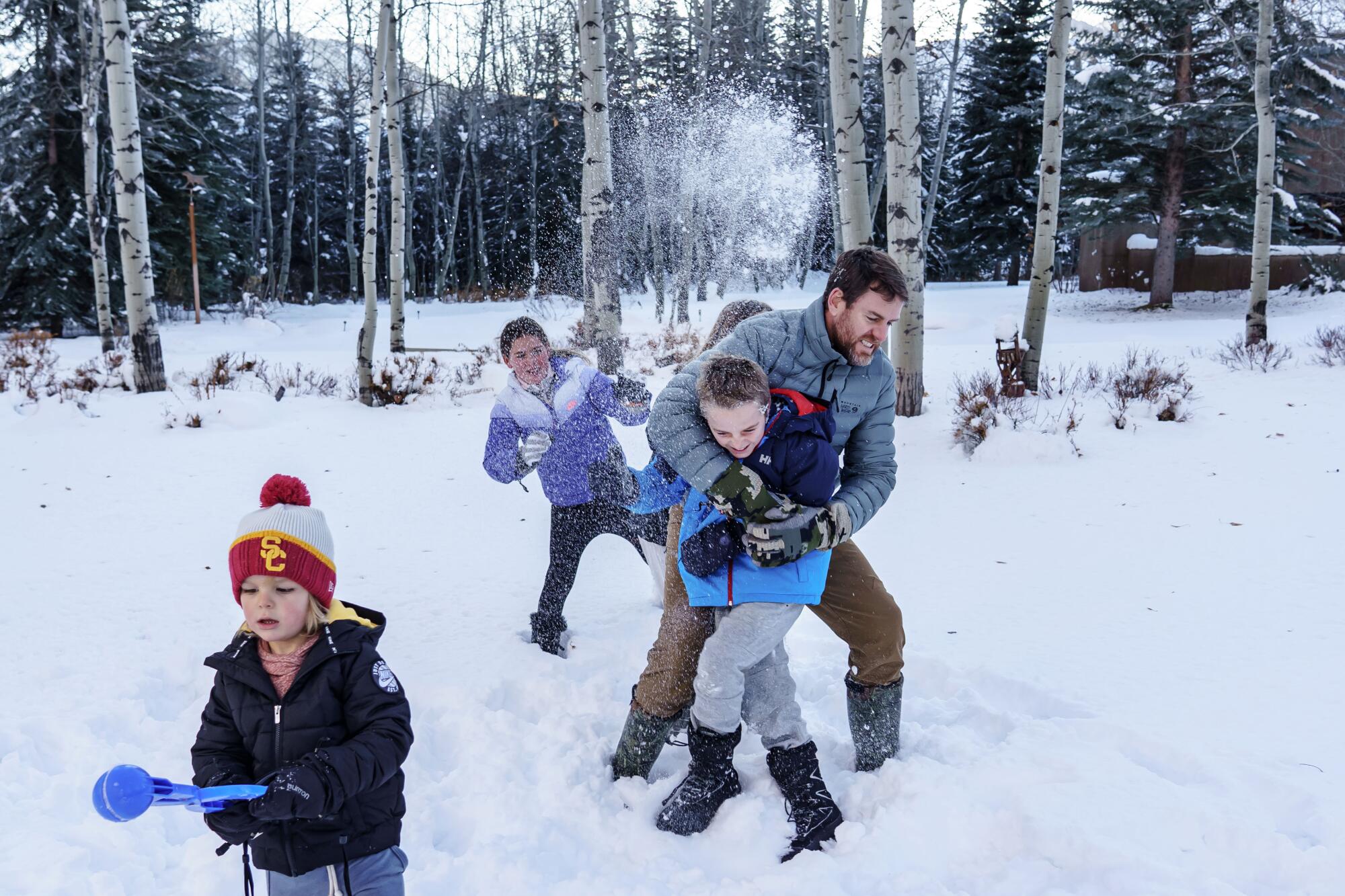 Carson Palmer gets hammered with a snowball as he tries to take a portrait with his children, in Ketchum, Idaho, in Dec. 2019