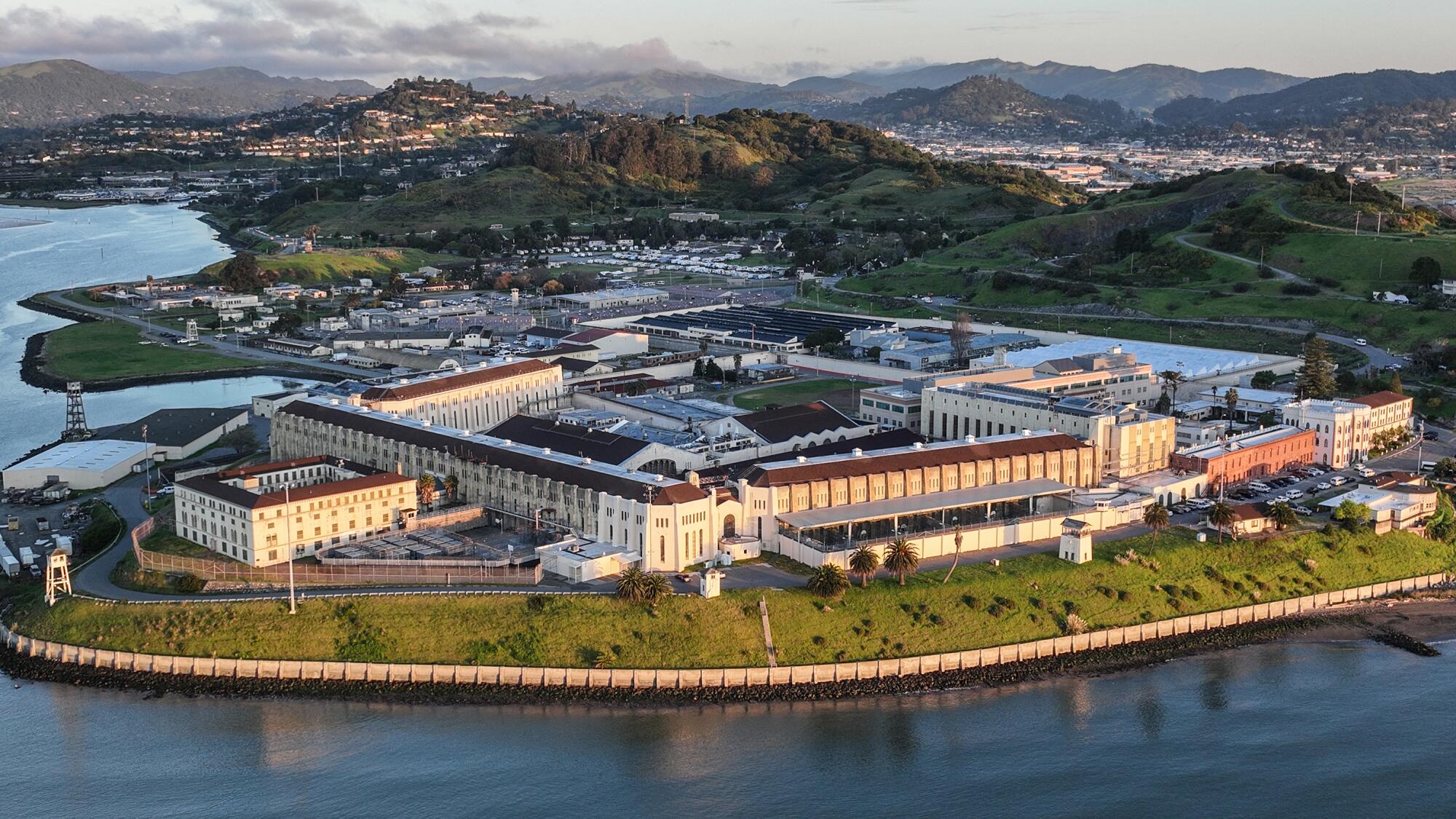 An aerial view of a building complex next to a bay.