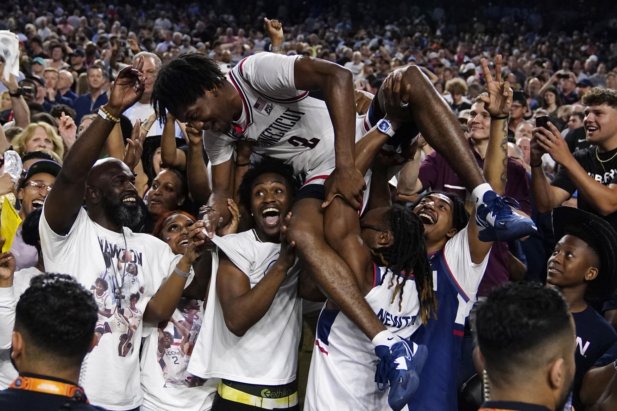 Connecticut players celebrating after their win against San Diego State to clinch a national championship