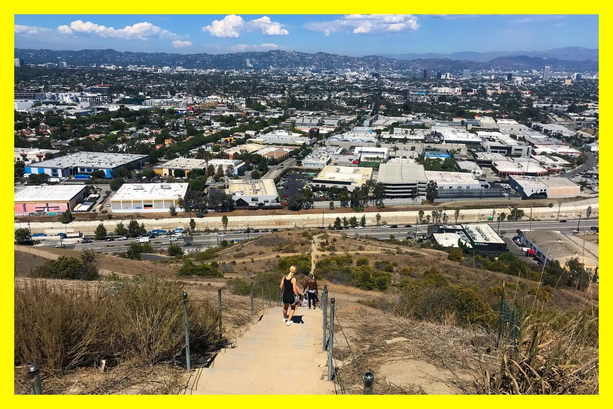 A few folks use the Culver Stairs next to a view of Los Angeles