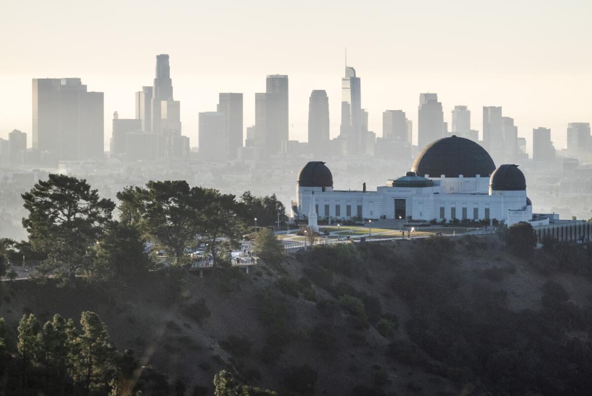 The Griffith Observatory against the downtown skyline as seen from the hiking trail at Griffith Park