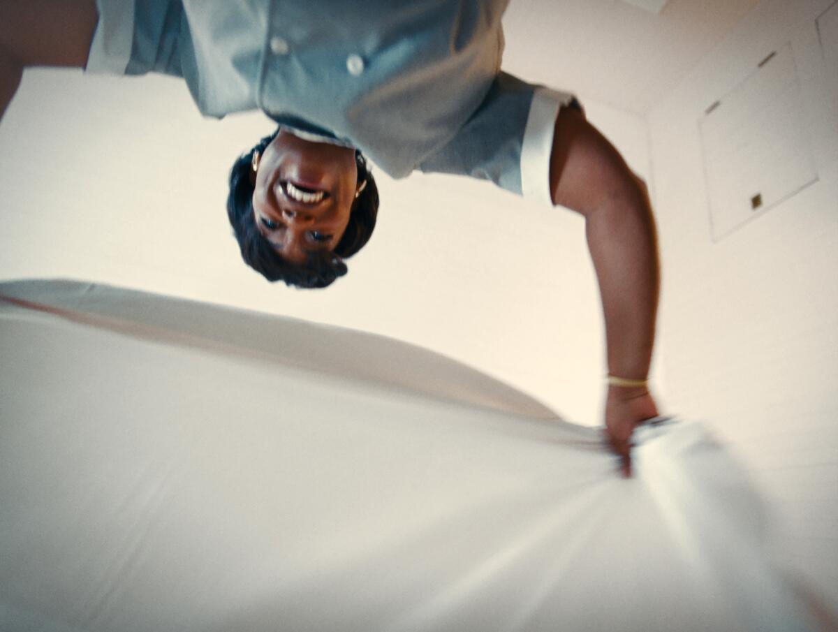 View from below of a woman raising a sheet in "Nickel Boys."