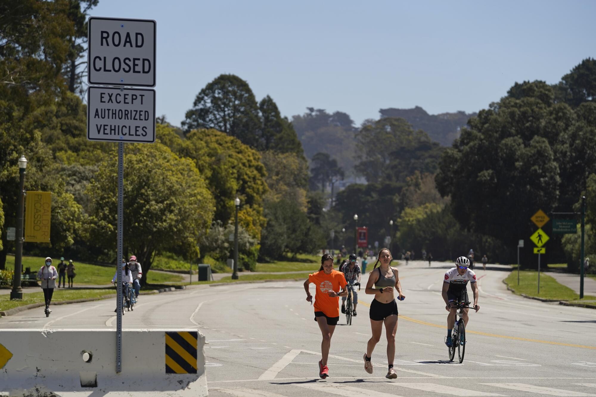 Joggers and cyclists make their way along car-free John F. Kennedy Drive in San Francisco's Golden Gate Park