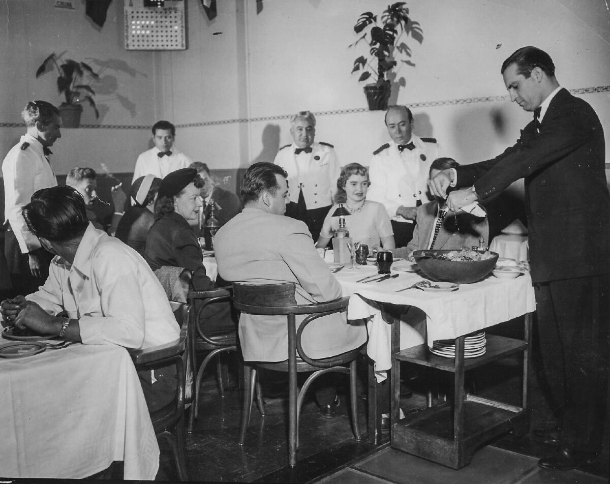 Carolynn Carreño's father, Guillermo Carreño, prepares a Caesar salad tableside at Jai Alai Frontón Palacio in Tijuana.