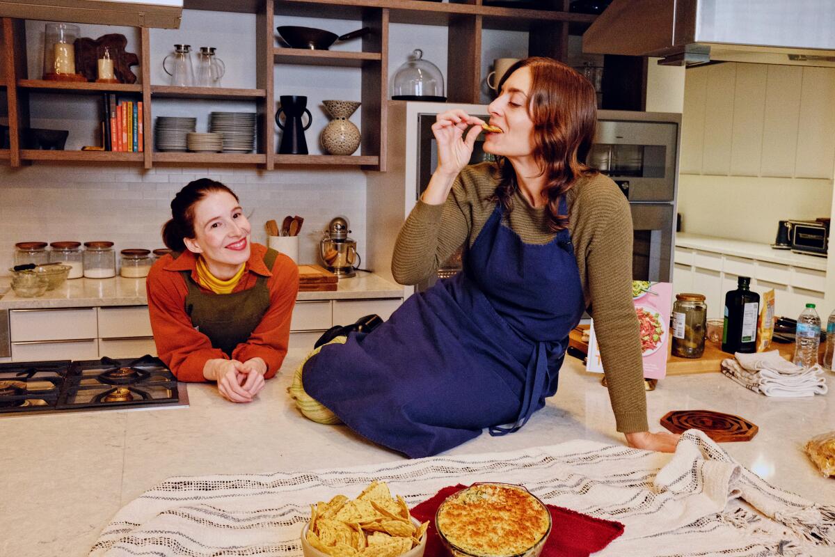 Kismet chefs Sara Kramer and Sarah Hymanson make a dip with cheese, greens and pickles in the L.A. Times Test Kitchen. 