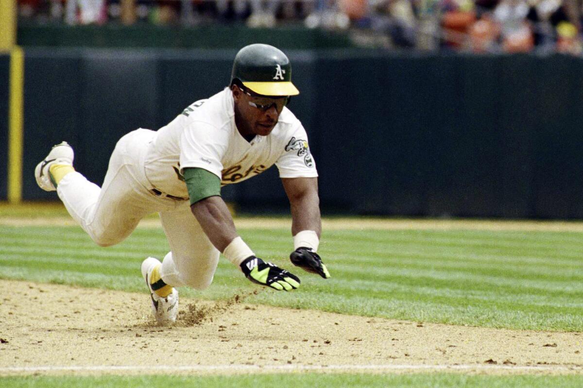 Rickey Henderson dives for third base to steal his 939th career base to set the all-time stolen base record.