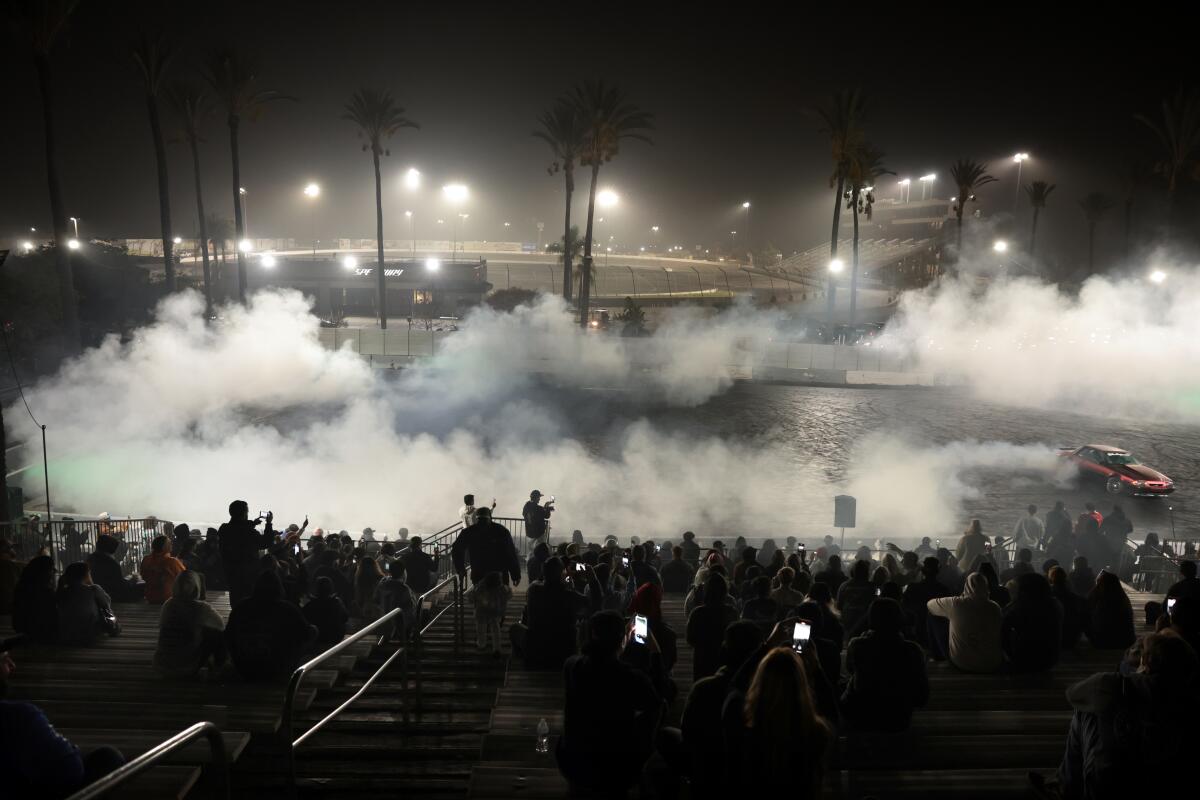 A car spins in the burnout box as fans watch on the final Thursday Night Thunder and Irwindale Speedway.