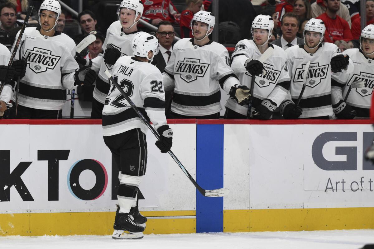 Kings left wing Kevin Fiala (No. 22) celebrates with teammates along the bench after his goal in the second period Sunday.