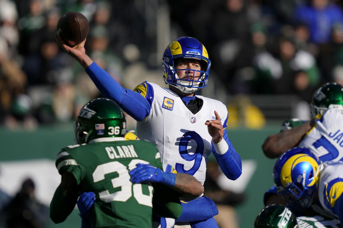 Rams quarterback Matthew Stafford (9) passes as New York Jets safety Chuck Clark applies pressure.