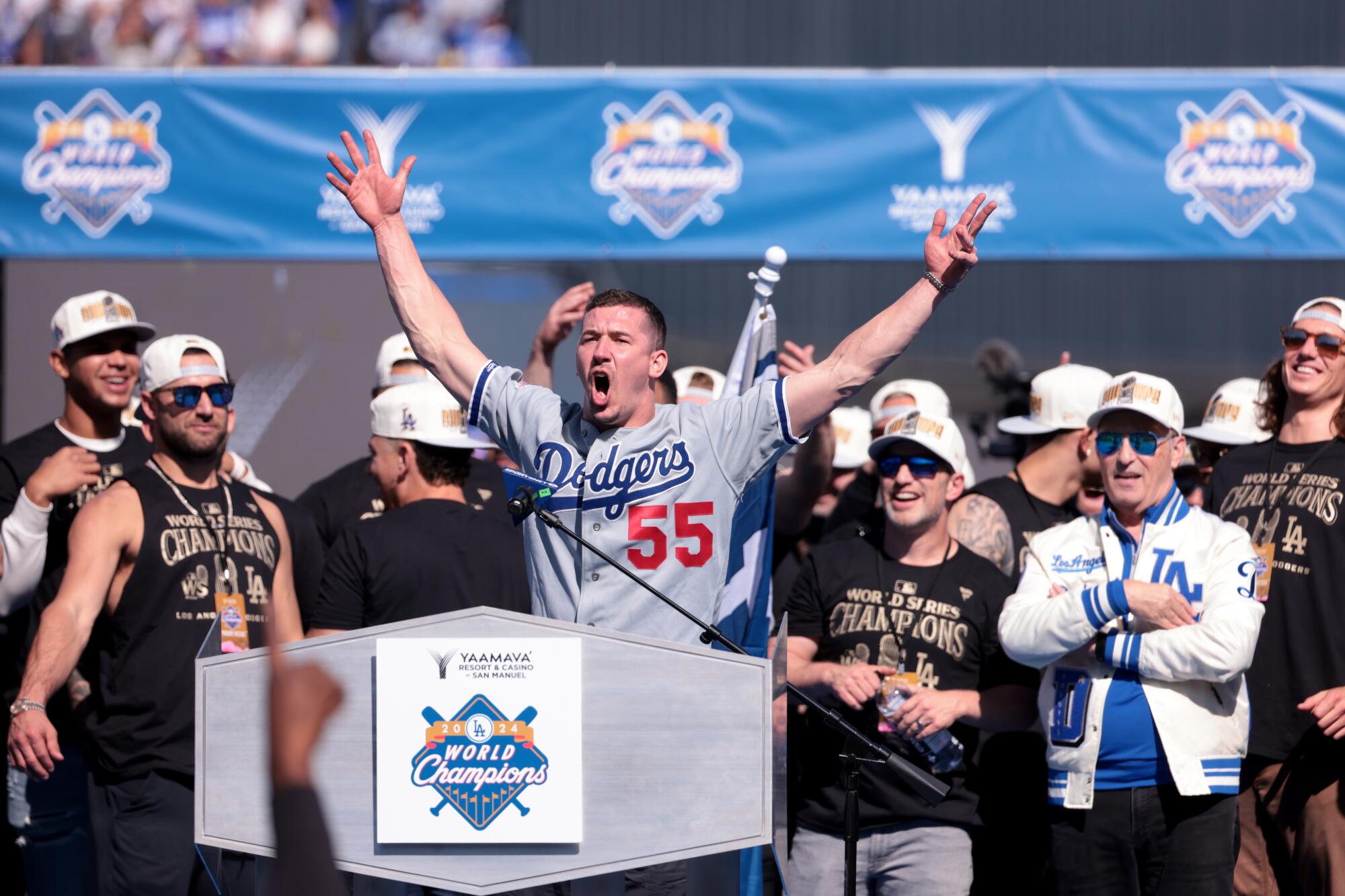 Walker Buehler, wearing an Orel Hershiser jersey, speaks at the championship celebration at Dodger Stadium last month.