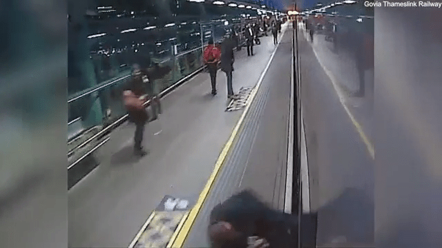 The man manages to push himself to safety as fellow rail users rush to help