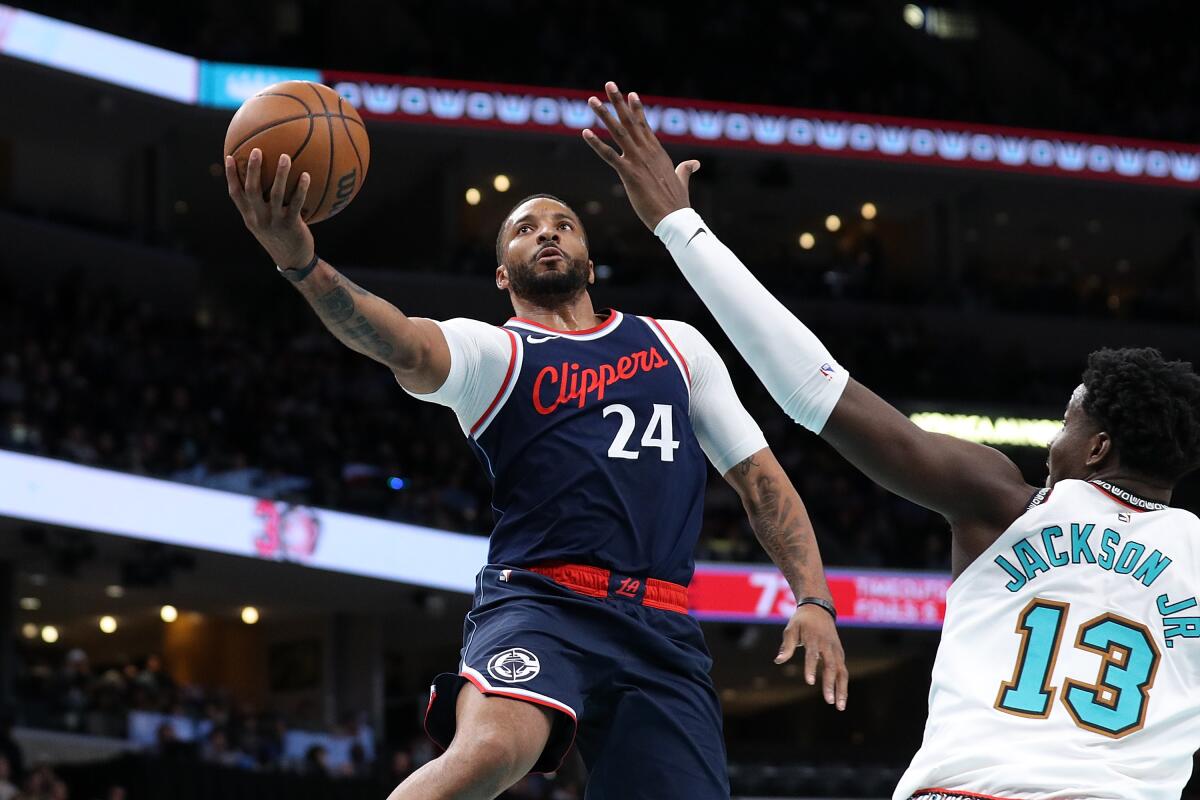 Clippers guard Norman Powell puts up a shot over Memphis forward Jaren Jackson Jr.