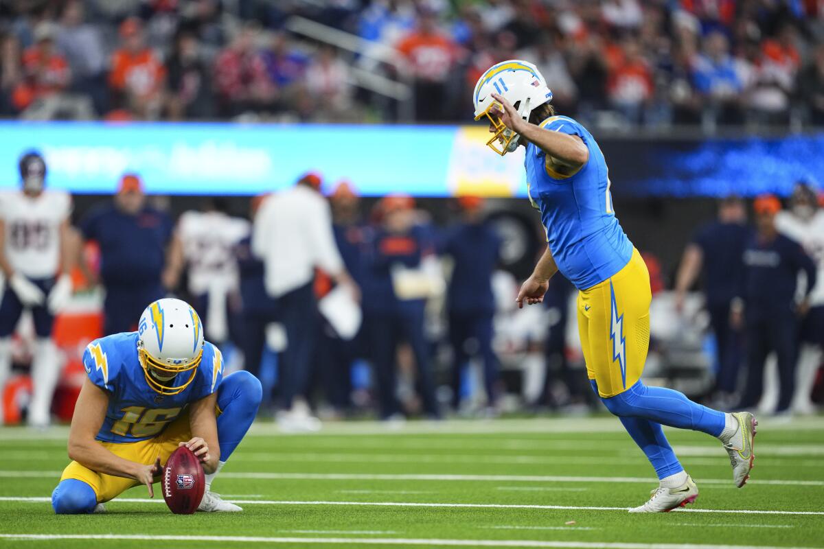 The Chargers' Cameron Dicker kicks a field goal as J.K. Scott holds.