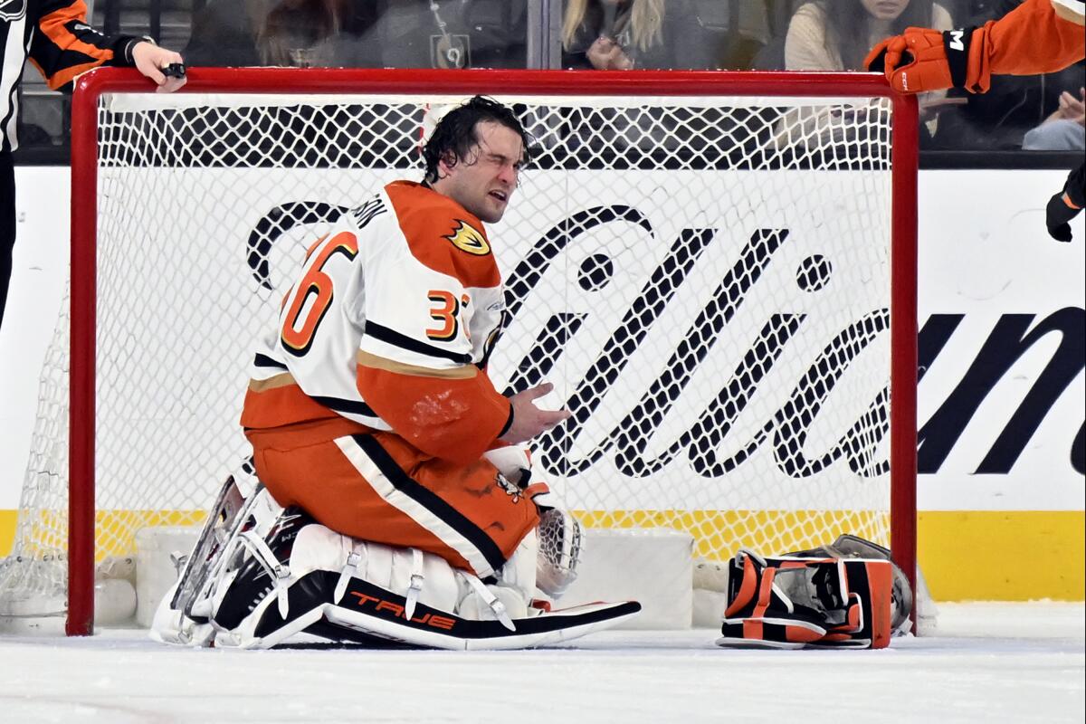 Ducks goaltender John Gibson reacts after getting hit with a stick blade in his right eye.