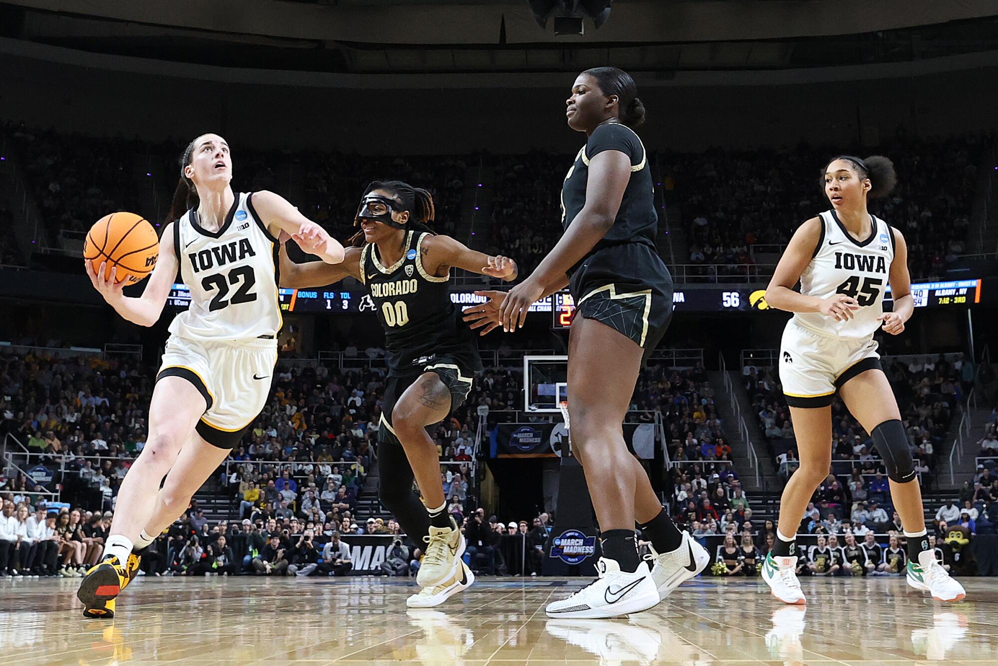 Iowa guard Caitlin Clark drives to the basket in front of Colorado's Jaylyn Sherrod during the NCAA tournament 