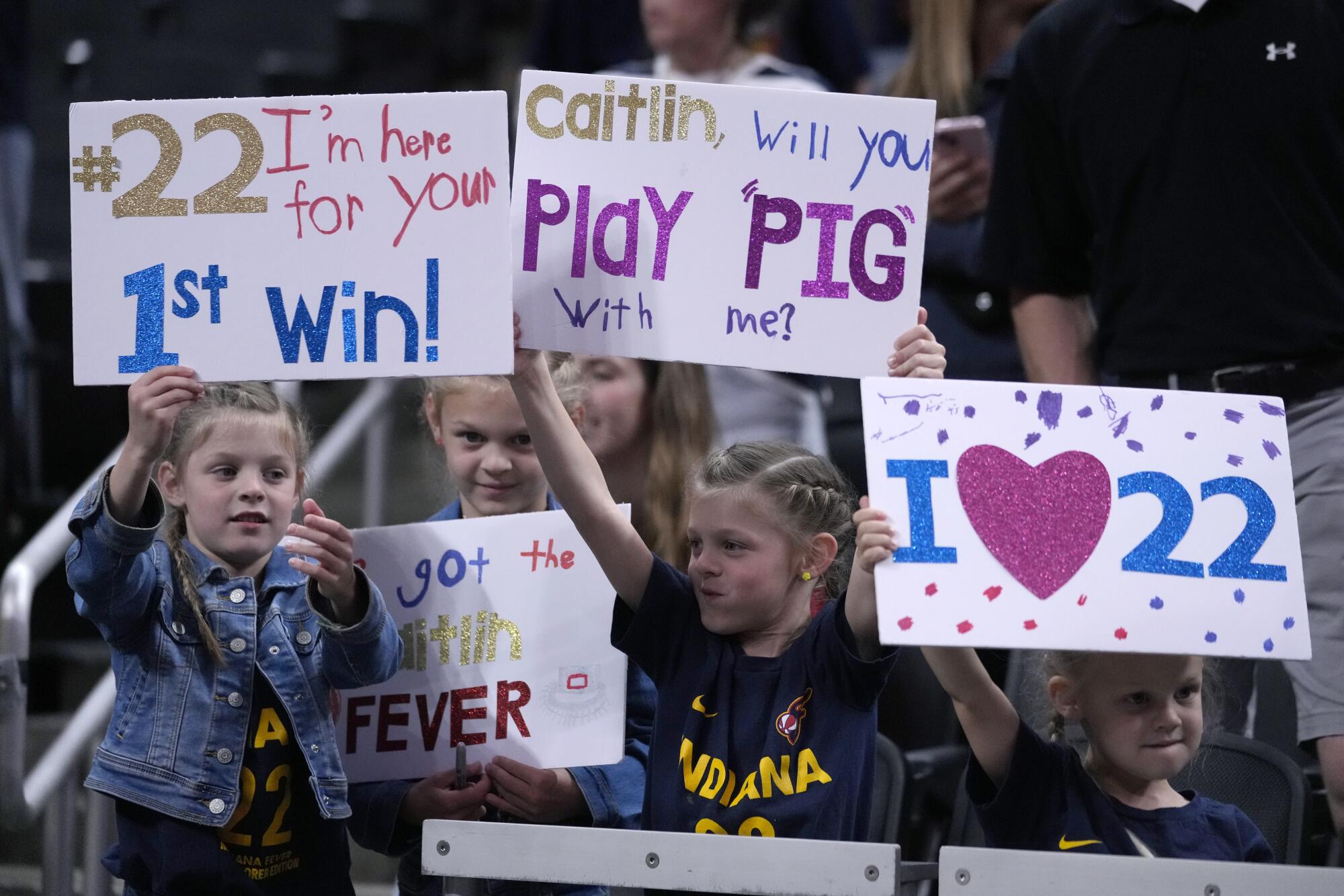 Fans watch Indiana Fever guard Caitlin Clark warm up before playing the New York Liberty on May 16 in Indianapolis.