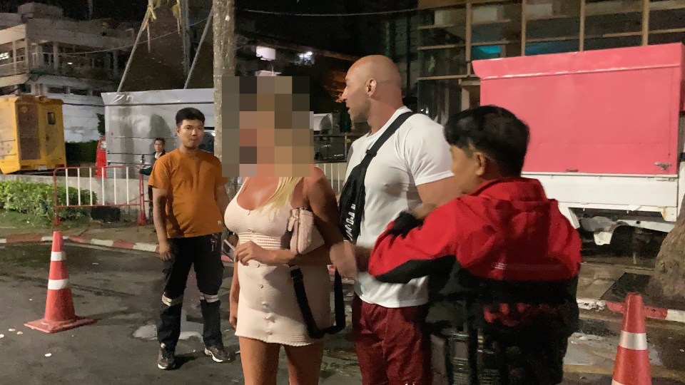 A bystander, dressed in a white T-shirt, had to intervene to help hotel staff drag her to the police station