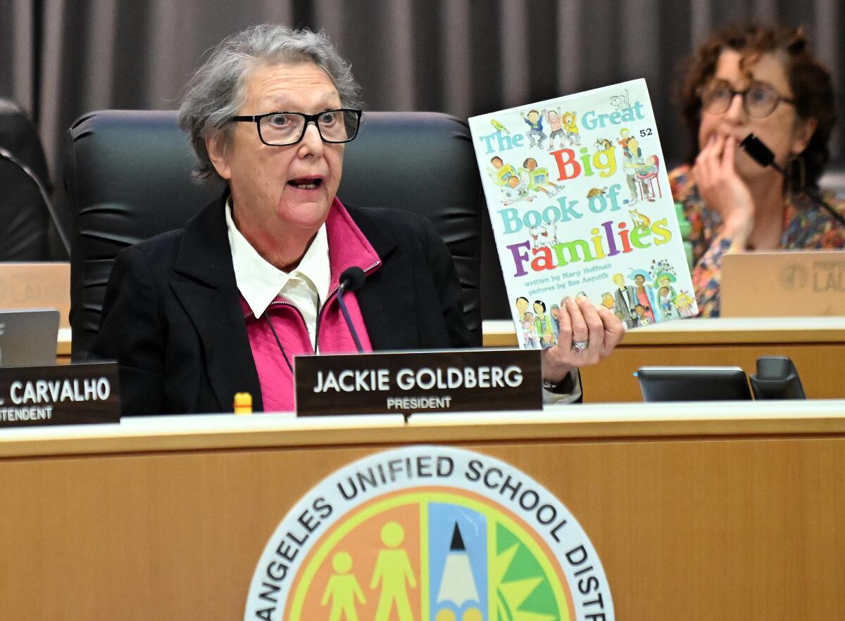 L.A. school board President Jackie Goldberg holds up a children's book.