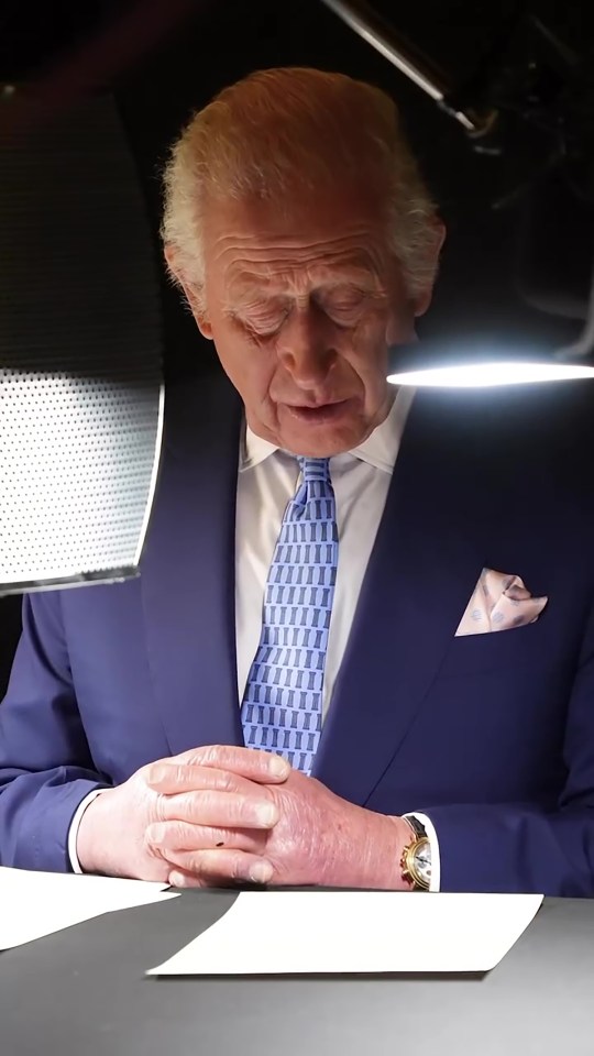 Charles sits at a desk practising his lines from a script