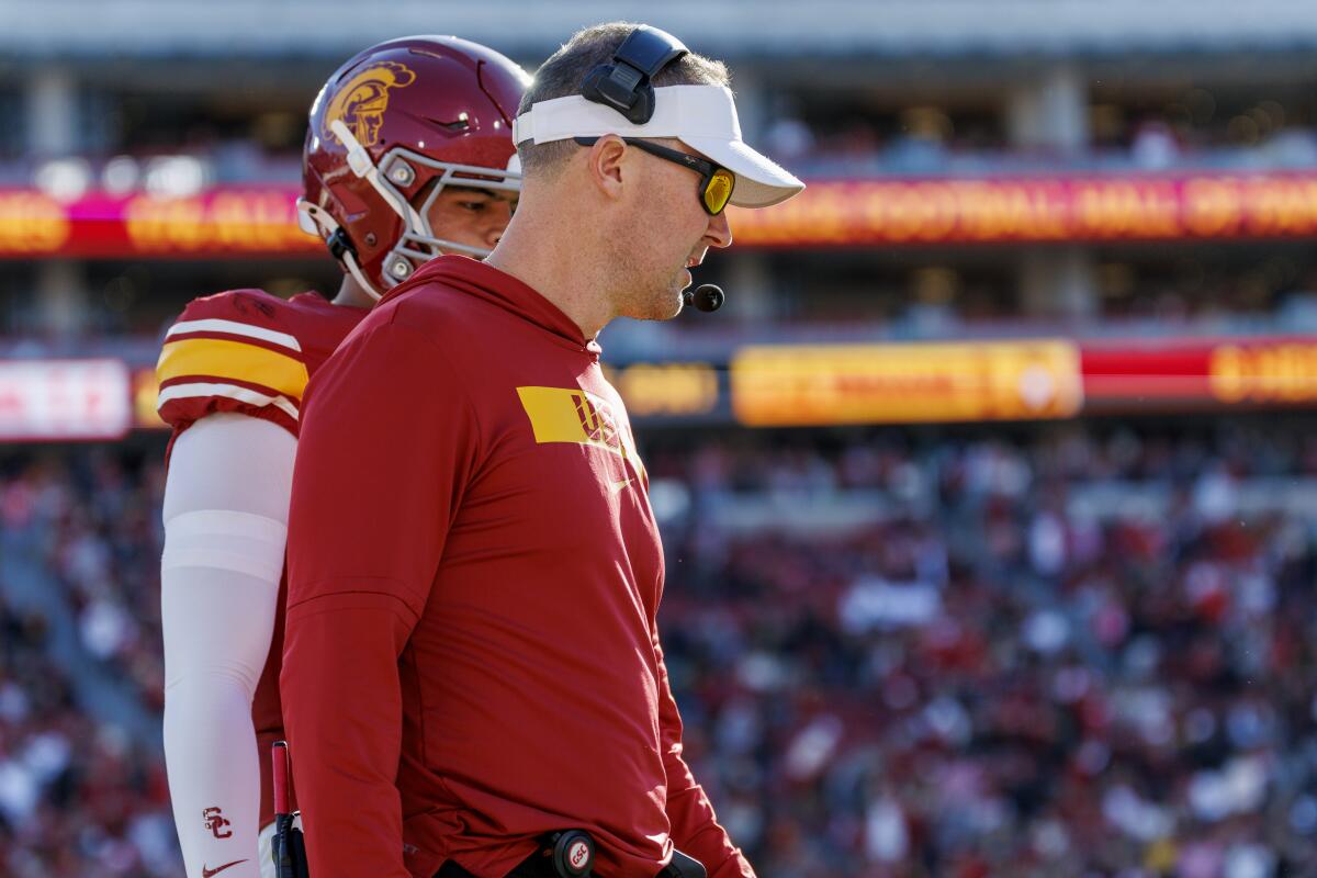 USC coach Lincoln Riley chats with quarterback Jayden Maiava during a win over Nebraska on Nov. 16 at the Coliseum.