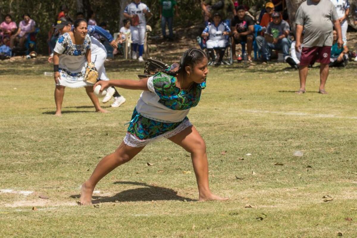 Las Amazonas de Yaxunah play a softball game during a visit by actor Yalitza Aparicio.