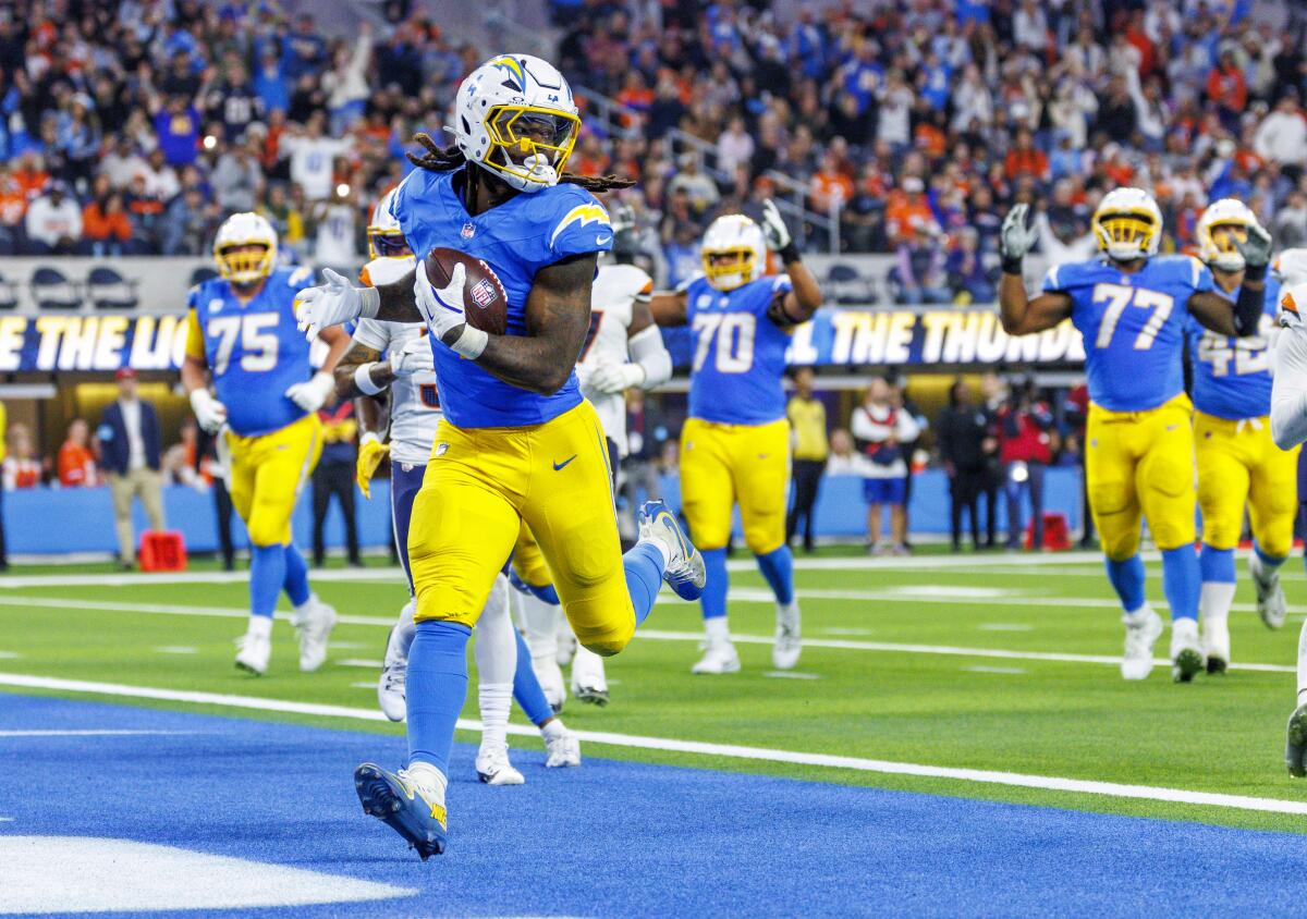 Chargers running back Gus Edwards scores against the Denver Broncos on Dec. 19.