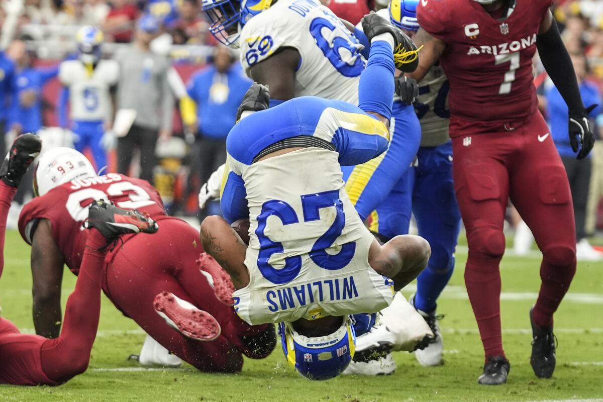 Rams running back Kyren Williams lands on his head as he scores a touchdown against the Cardinals.