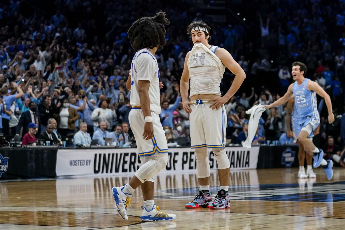 UCLA's Tyger Campbell, left, and Jaime Jaquez Jr. react during the final seconds of the Bruins' 73-66 loss to North Carolina.