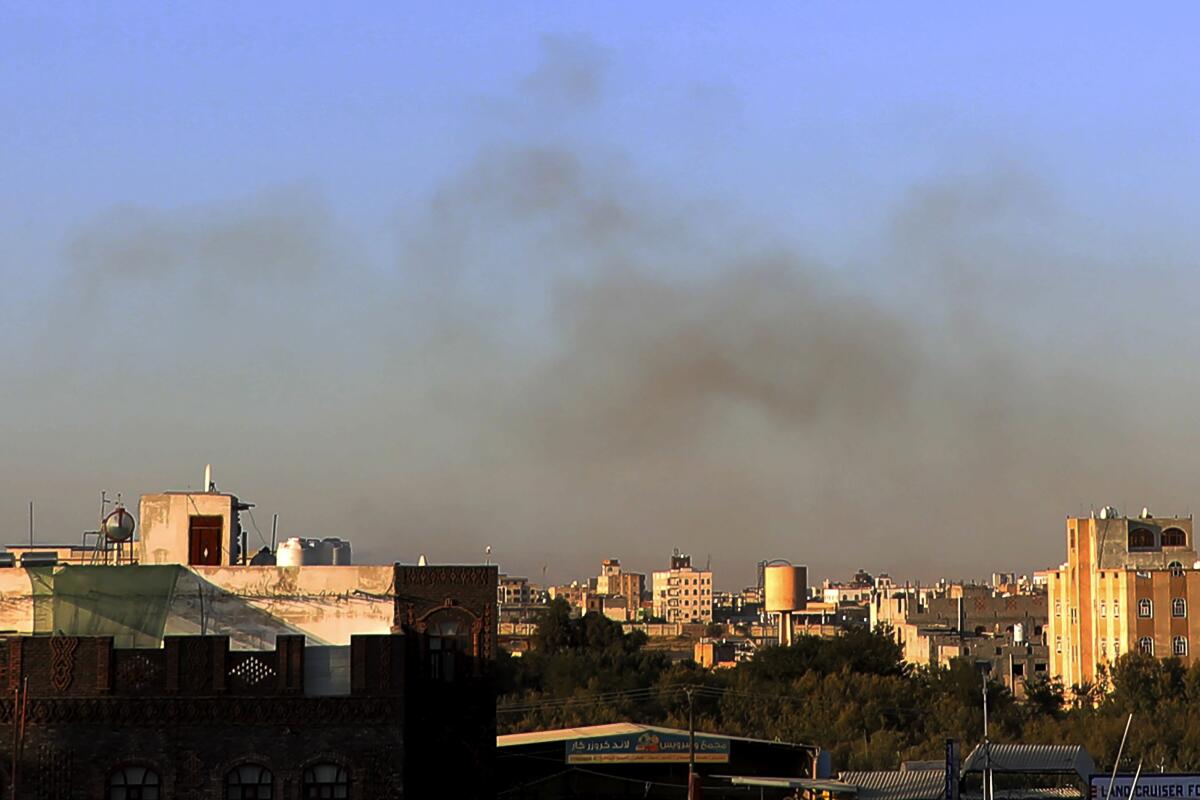 Smoke hovers above a skyline