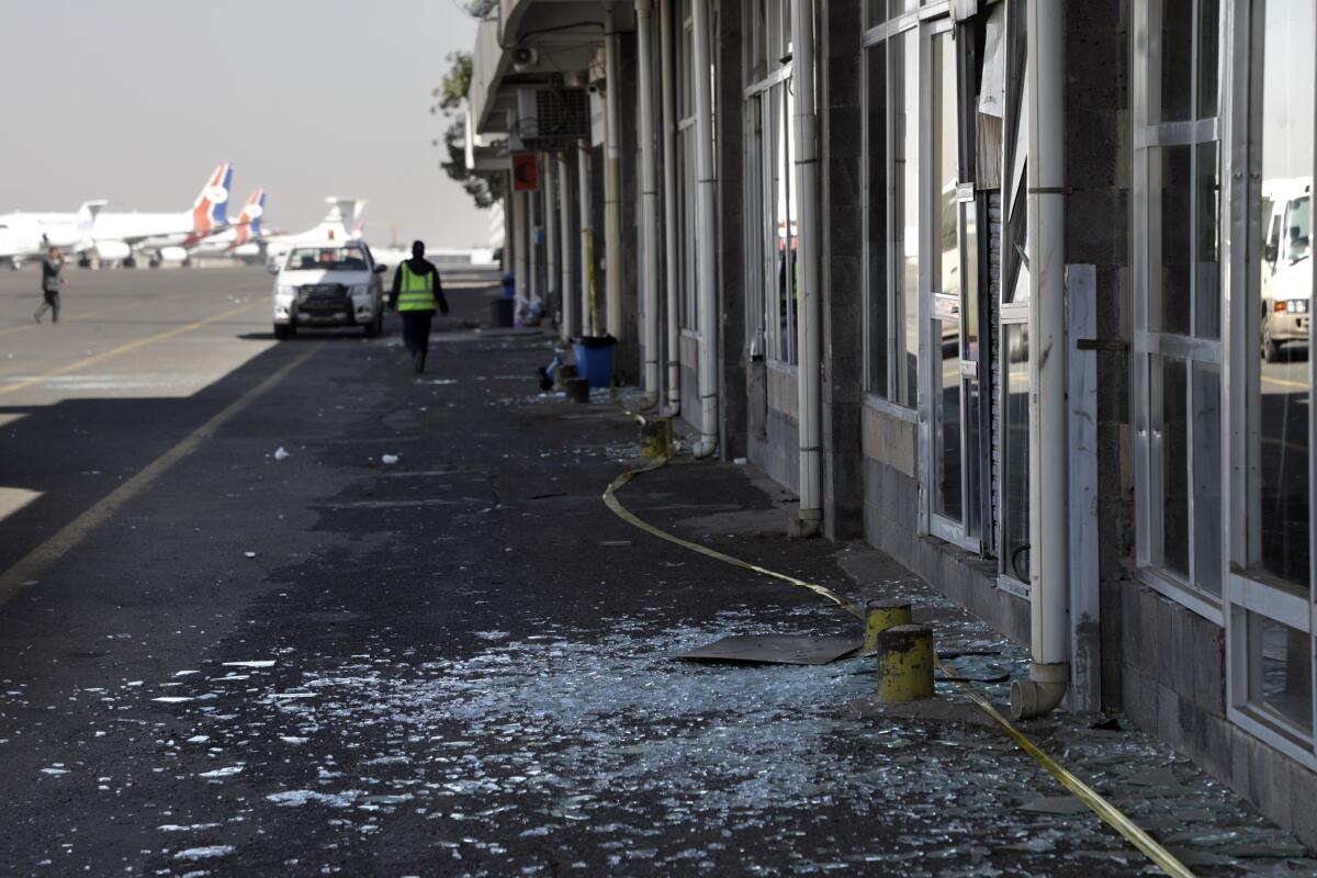 A pile of broken glass on pavement