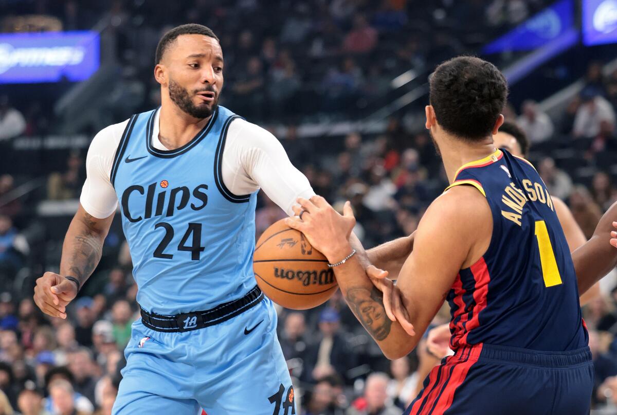 Clippers guard Norman Powell tries to steal the ball away from Warriors forward Kyle Anderson.