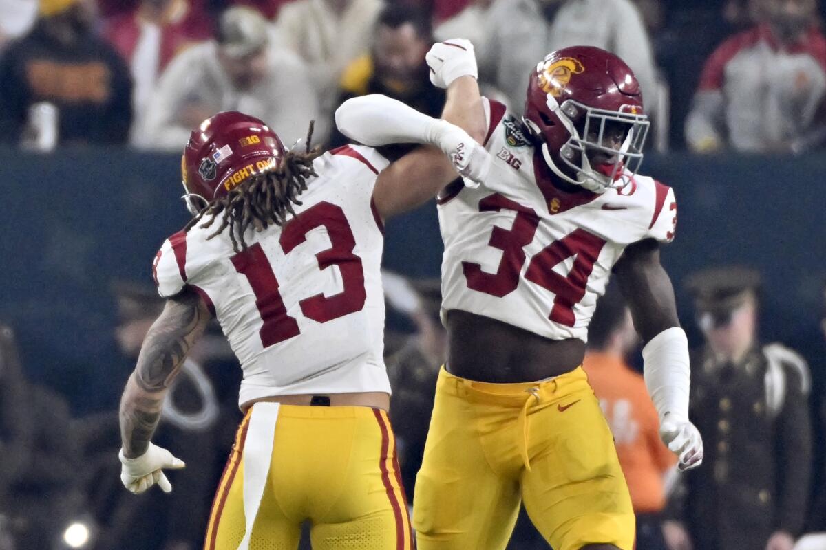 USC's Mason Cobb (13) and Braylan Shelby (34) react after making a play against the Texas A&M during the Las Vegas Bowl.