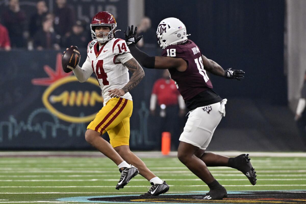 USC quarterback Jayden Maiava looks to pass under pressure from Texas A&M defensive lineman Cashius Howell.