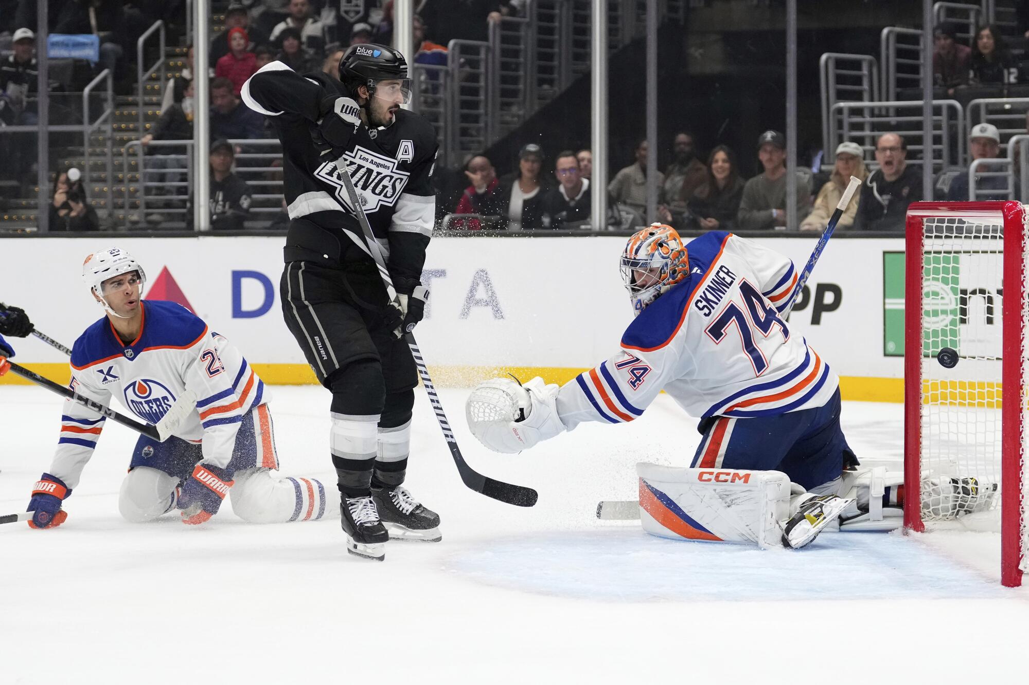 Edmonton Oilers goaltender Stuart Skinner gives up the winning goal in overtime in front of Kings forward Phillip Danault.