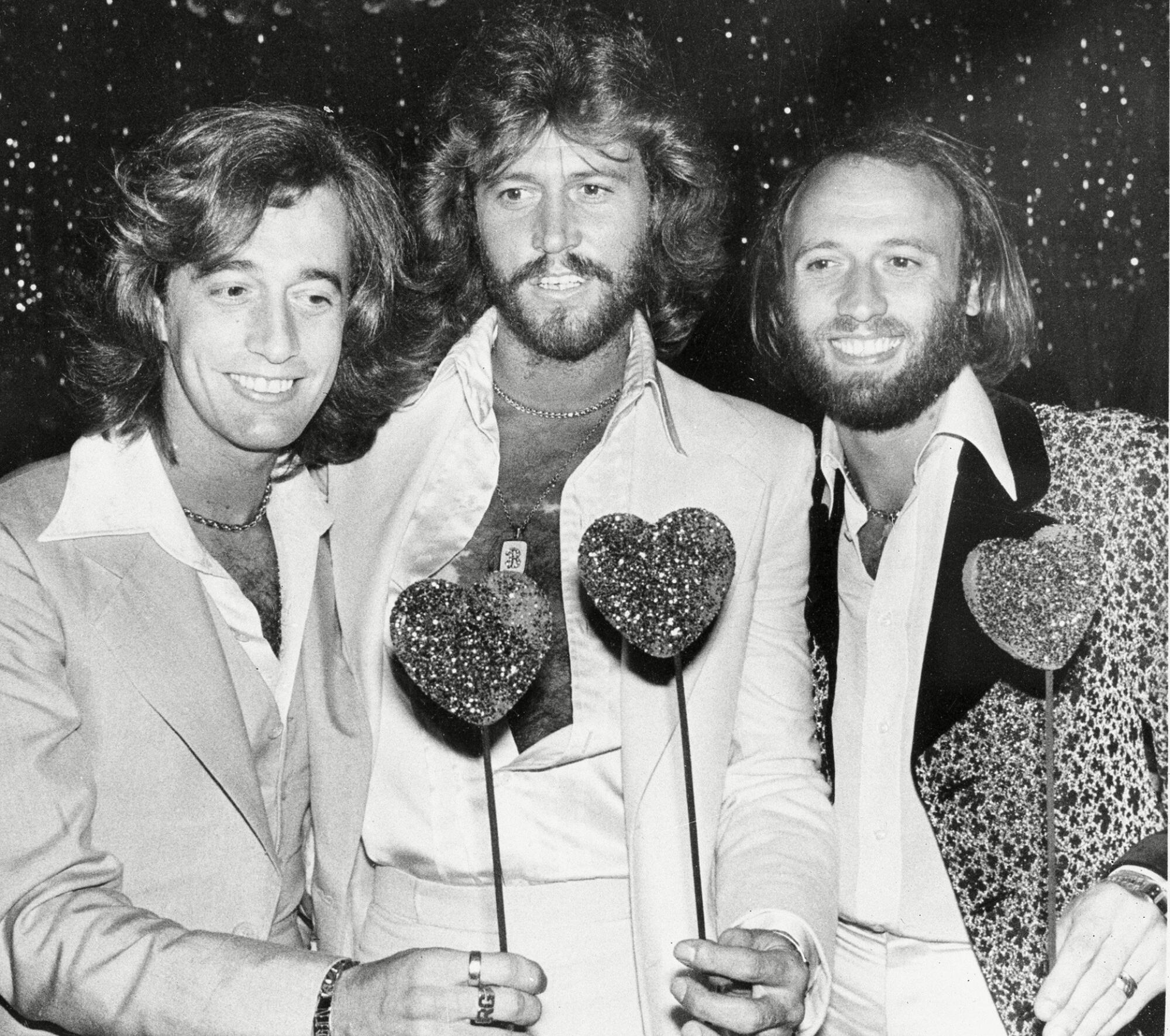 The Bee Gees, from left, Robin, Barry and Maurice Gibb, attend a party following the Hollywood premiere