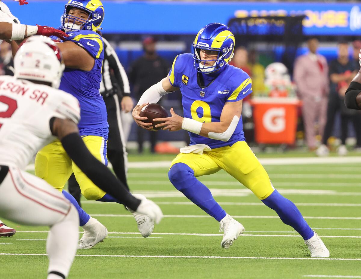 Rams quarterback Matthew Stafford scrambles for a first down against the Cardinals in the first half.