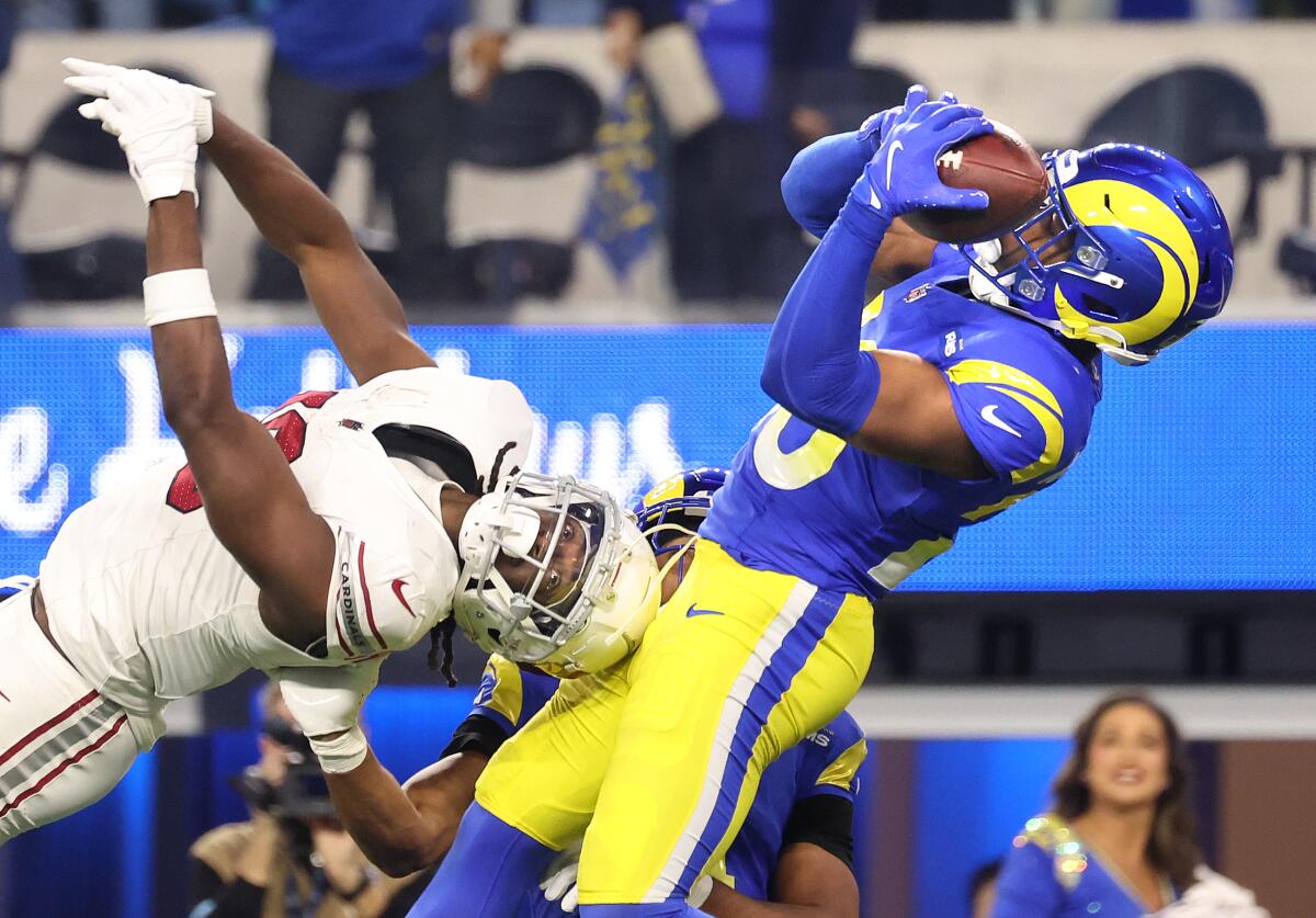 The Rams' Kamren Kitchens leaps to intercepts a pass intended for the Cardinals'  Marvin Harrison Jr. in the fourth quarter.